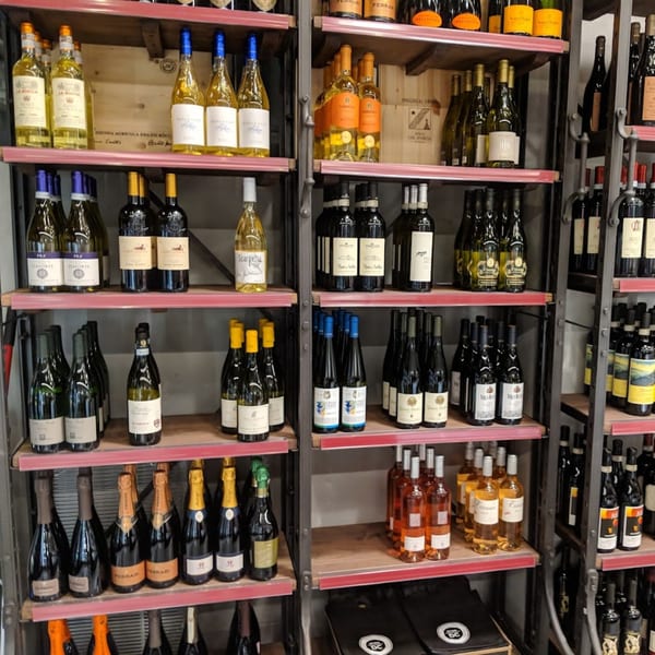 Officina's wine cellar displays a wide selection of Italian red, white, and sparkling wines.